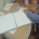 Ръце върху отворени страници на брайлов комикс